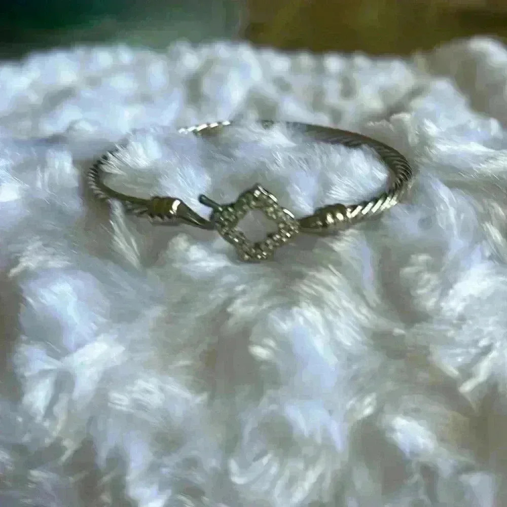 Silver tone open diamond shape twisted metal bracelet with hook and eye closer
